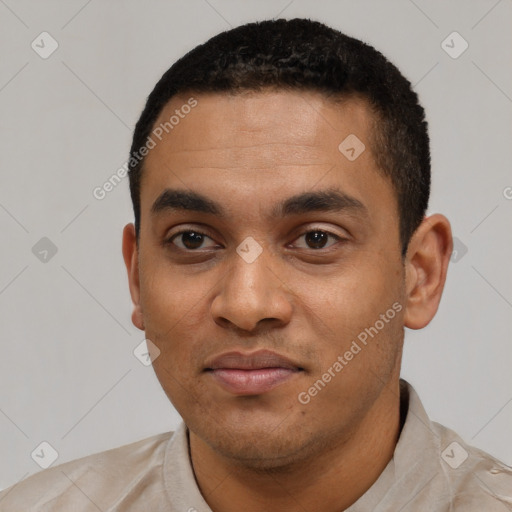 Joyful black young-adult male with short  black hair and brown eyes