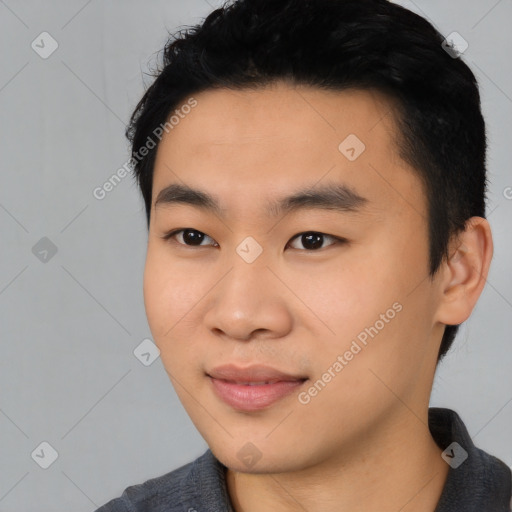 Joyful asian young-adult male with short  black hair and brown eyes