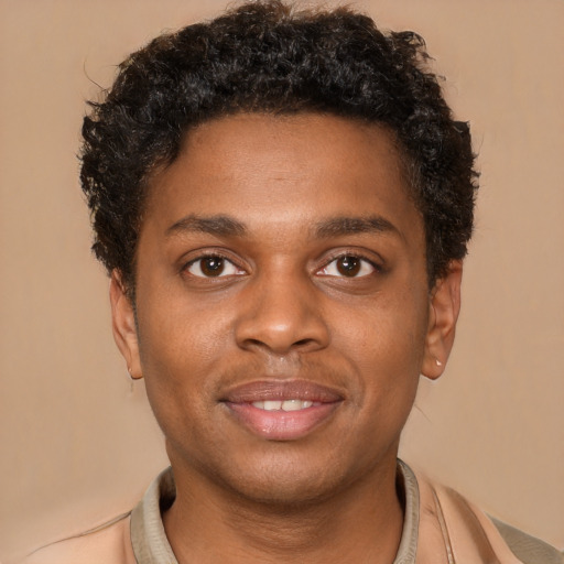 Joyful black young-adult male with short  brown hair and brown eyes