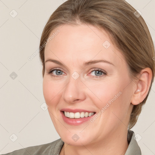 Joyful white adult female with medium  brown hair and grey eyes