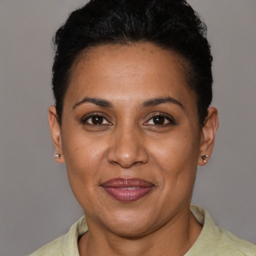 Joyful latino adult female with short  brown hair and brown eyes