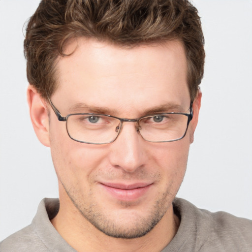 Joyful white adult male with short  brown hair and grey eyes