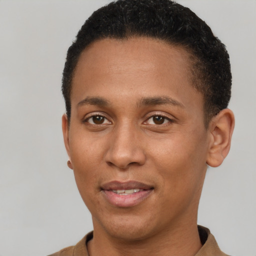 Joyful black young-adult male with short  brown hair and brown eyes