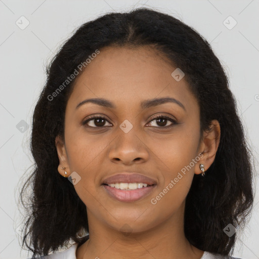 Joyful black young-adult female with long  brown hair and brown eyes