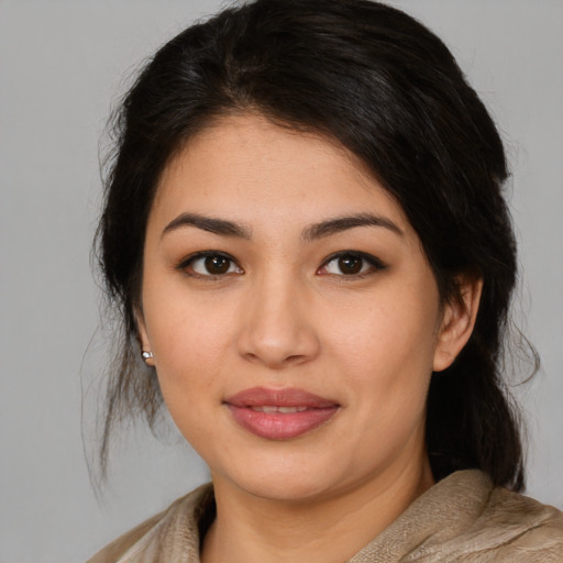 Joyful latino young-adult female with medium  brown hair and brown eyes