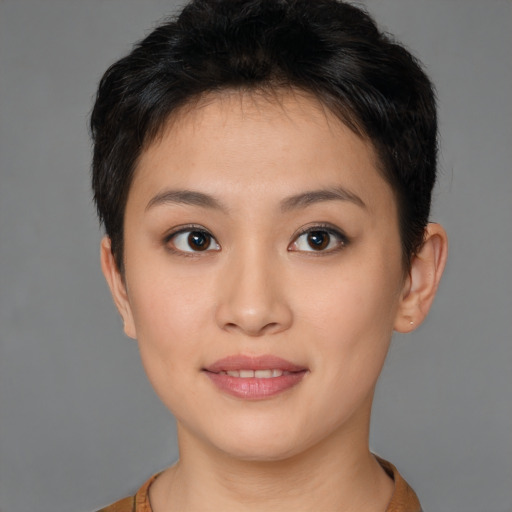 Joyful asian young-adult female with short  brown hair and brown eyes