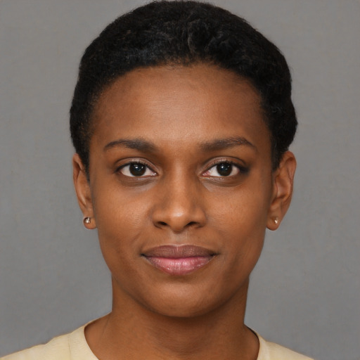 Joyful black young-adult female with short  black hair and brown eyes