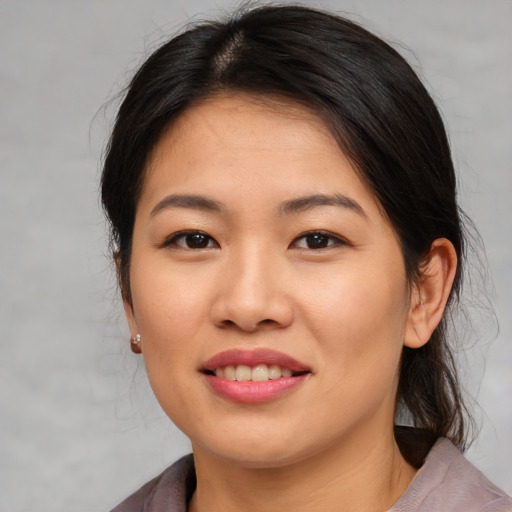 Joyful asian young-adult female with medium  brown hair and brown eyes