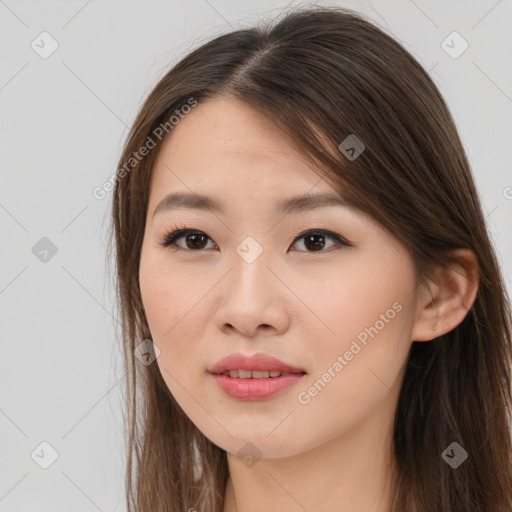 Joyful asian young-adult female with long  brown hair and brown eyes