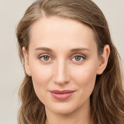 Joyful white young-adult female with long  brown hair and blue eyes