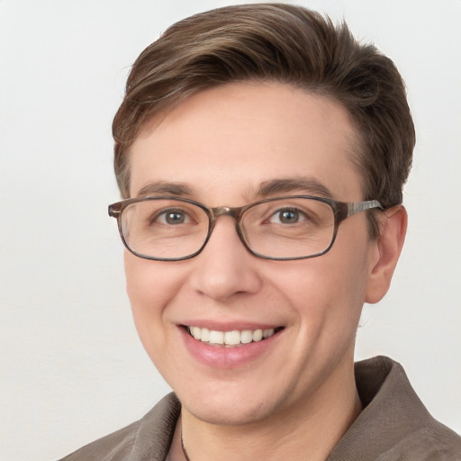 Joyful white young-adult male with short  brown hair and blue eyes