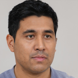 Neutral latino young-adult male with short  black hair and brown eyes