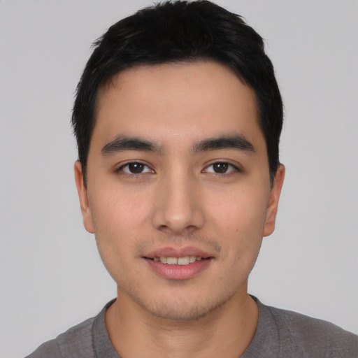 Joyful asian young-adult male with short  black hair and brown eyes