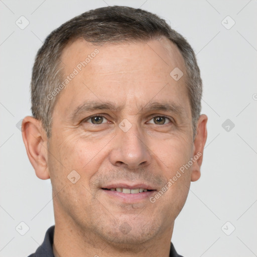 Joyful white adult male with short  brown hair and brown eyes