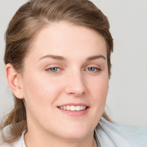 Joyful white young-adult female with medium  brown hair and blue eyes