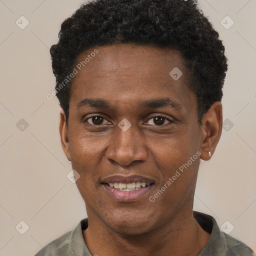 Joyful black adult male with short  black hair and brown eyes