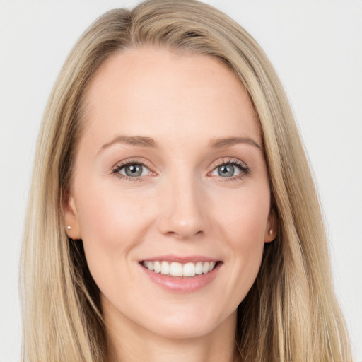 Joyful white young-adult female with long  brown hair and blue eyes