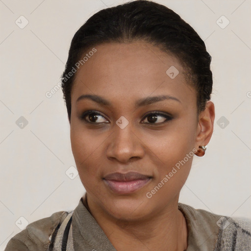 Joyful black young-adult female with short  black hair and brown eyes