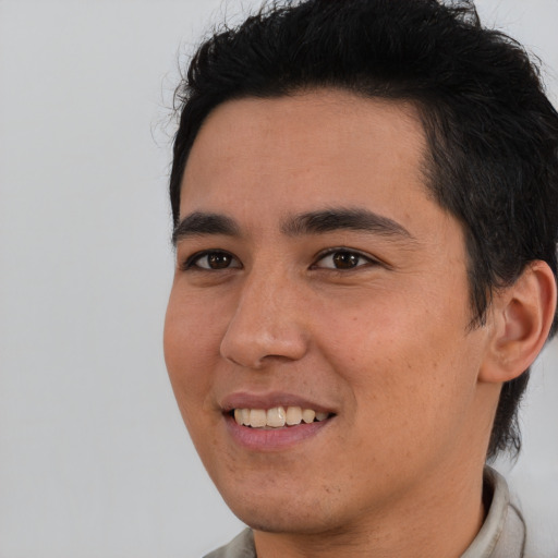 Joyful latino young-adult male with short  brown hair and brown eyes