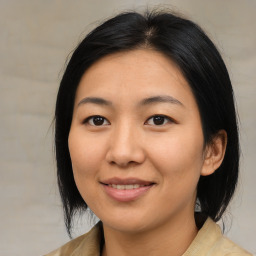 Joyful asian young-adult female with medium  black hair and brown eyes