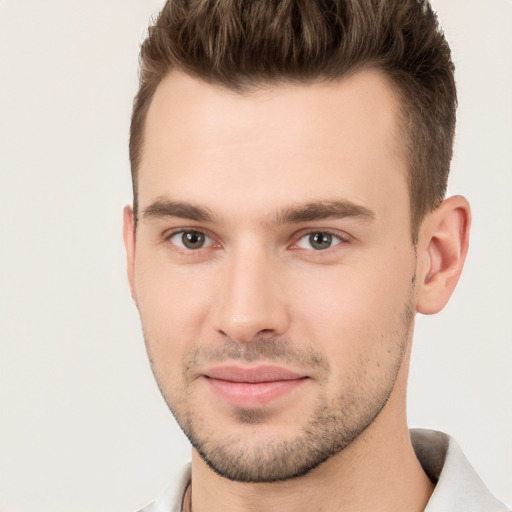 Joyful white young-adult male with short  brown hair and brown eyes