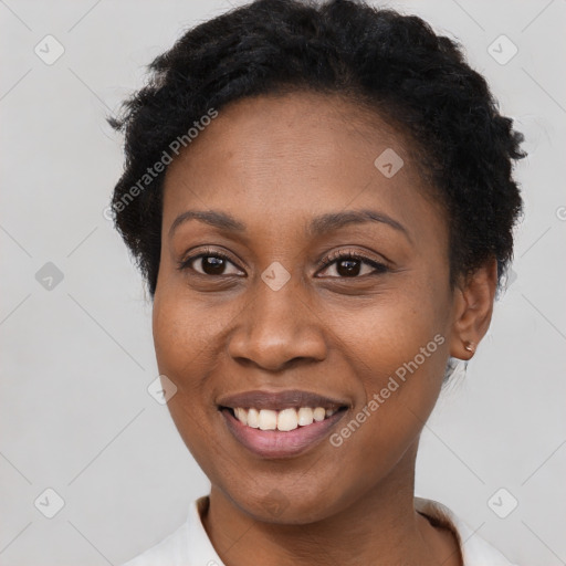 Joyful black young-adult female with short  brown hair and brown eyes