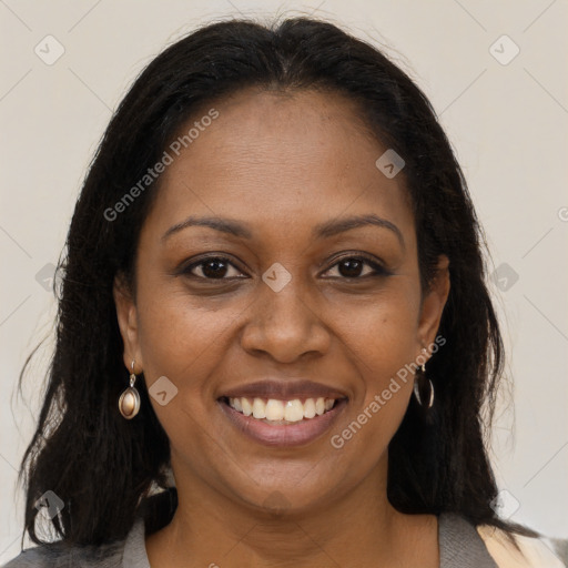 Joyful black young-adult female with long  brown hair and brown eyes