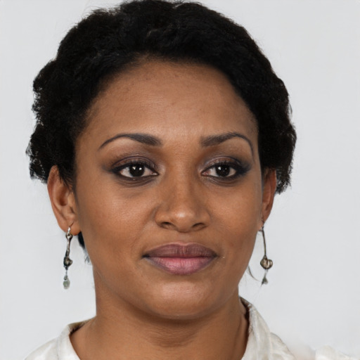 Joyful black adult female with short  black hair and brown eyes