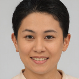 Joyful asian young-adult female with short  brown hair and brown eyes