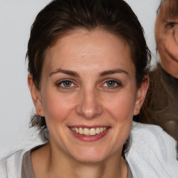 Joyful white adult female with medium  brown hair and brown eyes