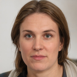 Joyful white adult female with medium  brown hair and grey eyes