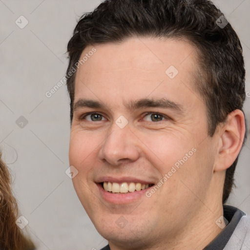 Joyful white young-adult male with short  brown hair and brown eyes