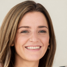 Joyful white young-adult female with long  brown hair and green eyes