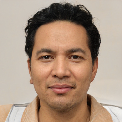 Joyful white adult male with short  black hair and brown eyes