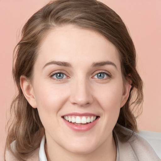 Joyful white young-adult female with medium  brown hair and blue eyes