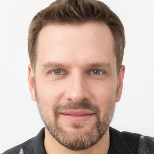 Joyful white adult male with short  brown hair and grey eyes