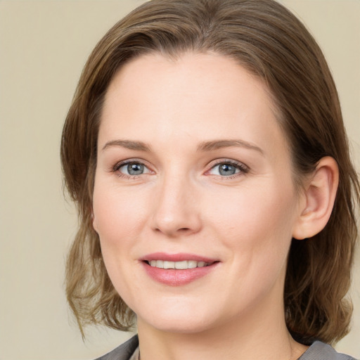 Joyful white young-adult female with medium  brown hair and blue eyes