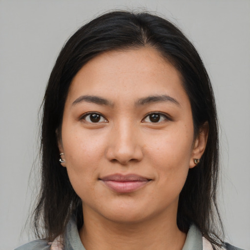 Joyful latino young-adult female with medium  brown hair and brown eyes