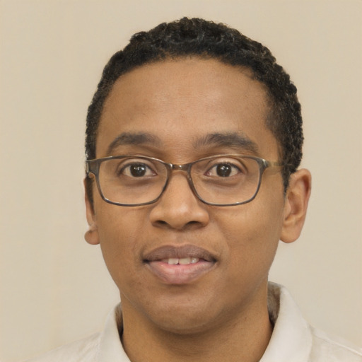 Joyful black adult male with short  black hair and brown eyes