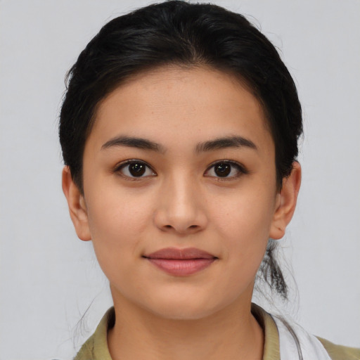 Joyful asian young-adult female with medium  black hair and brown eyes