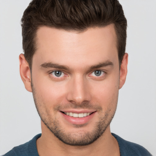 Joyful white young-adult male with short  brown hair and brown eyes