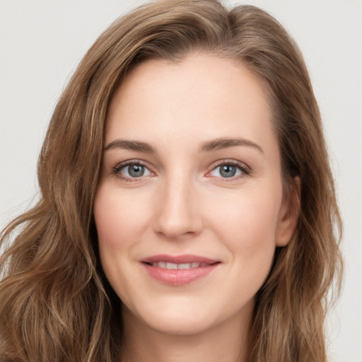 Joyful white young-adult female with long  brown hair and green eyes