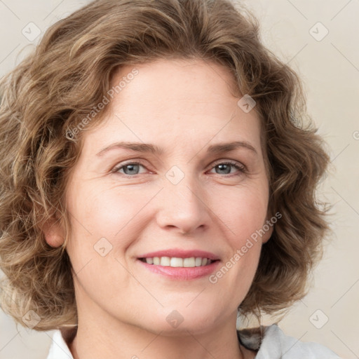 Joyful white adult female with medium  brown hair and green eyes