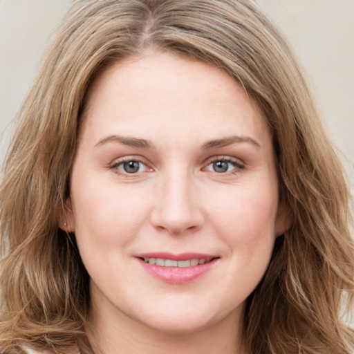 Joyful white young-adult female with long  brown hair and green eyes