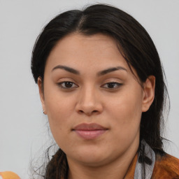 Joyful latino young-adult female with long  brown hair and brown eyes