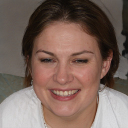 Joyful white adult female with medium  brown hair and brown eyes