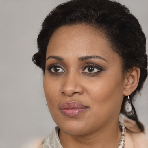 Joyful black young-adult female with medium  brown hair and brown eyes