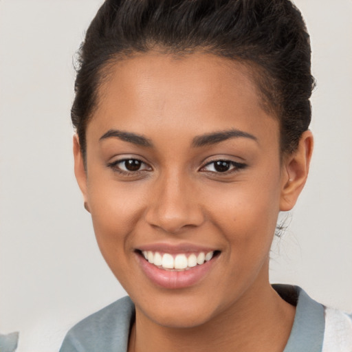 Joyful latino young-adult female with short  brown hair and brown eyes