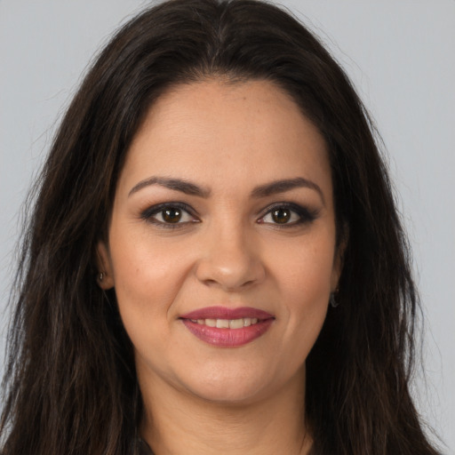 Joyful white young-adult female with long  brown hair and brown eyes