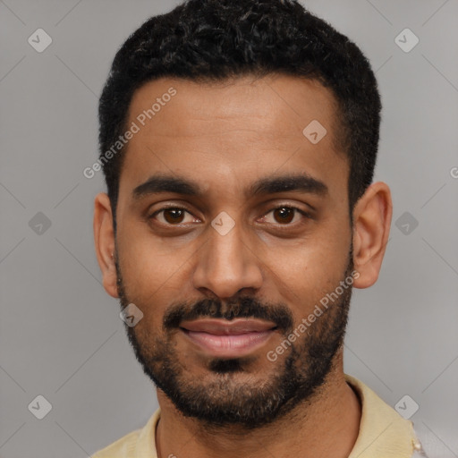 Joyful black young-adult male with short  black hair and brown eyes